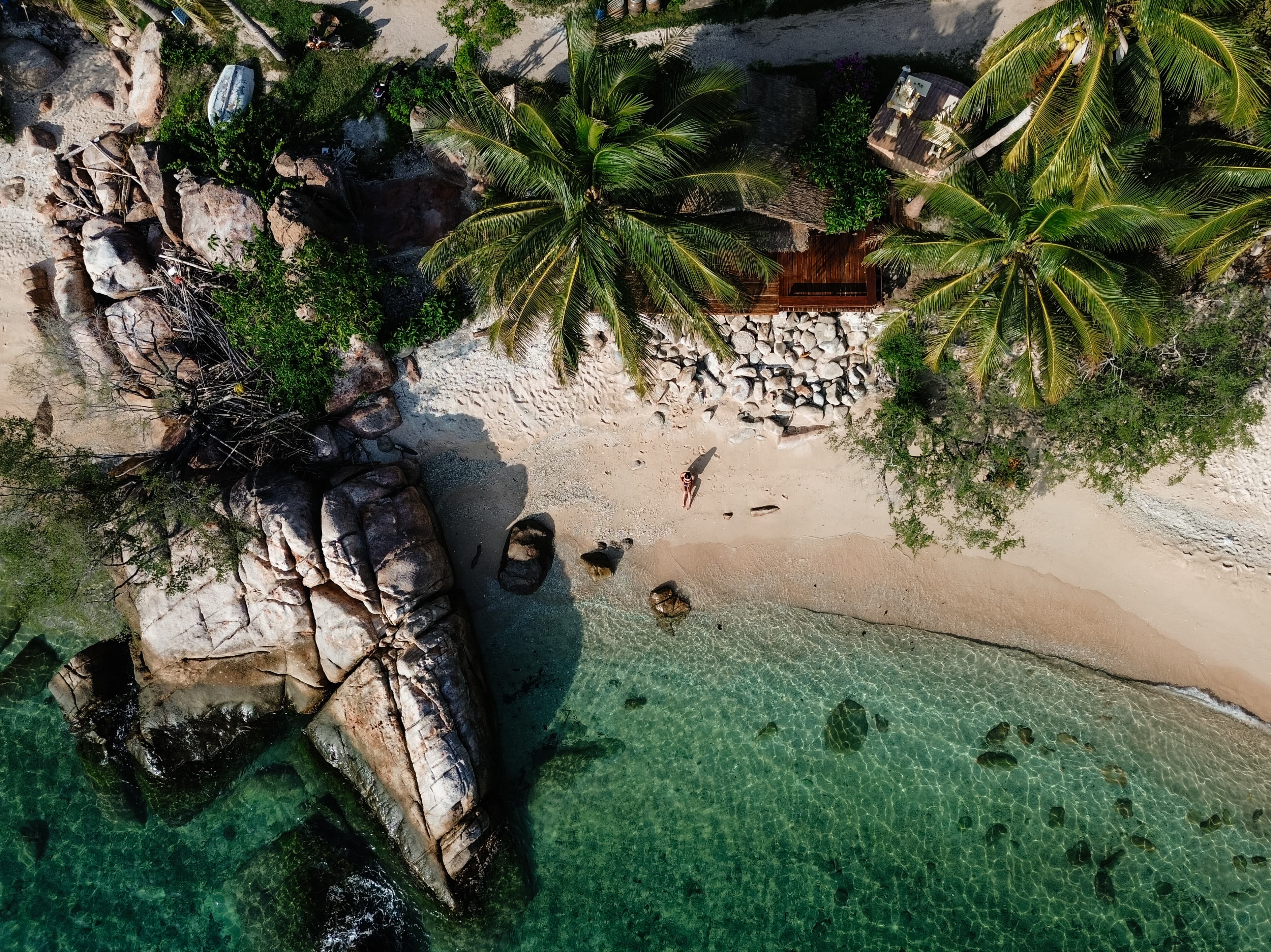 Vue panoramique d'une jeune femme assise sur une plage en Thaïlande
